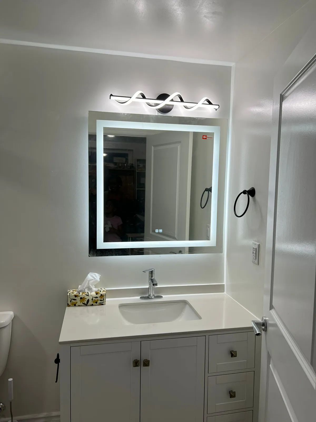 Backlit LED smart mirror and white shaker vanity