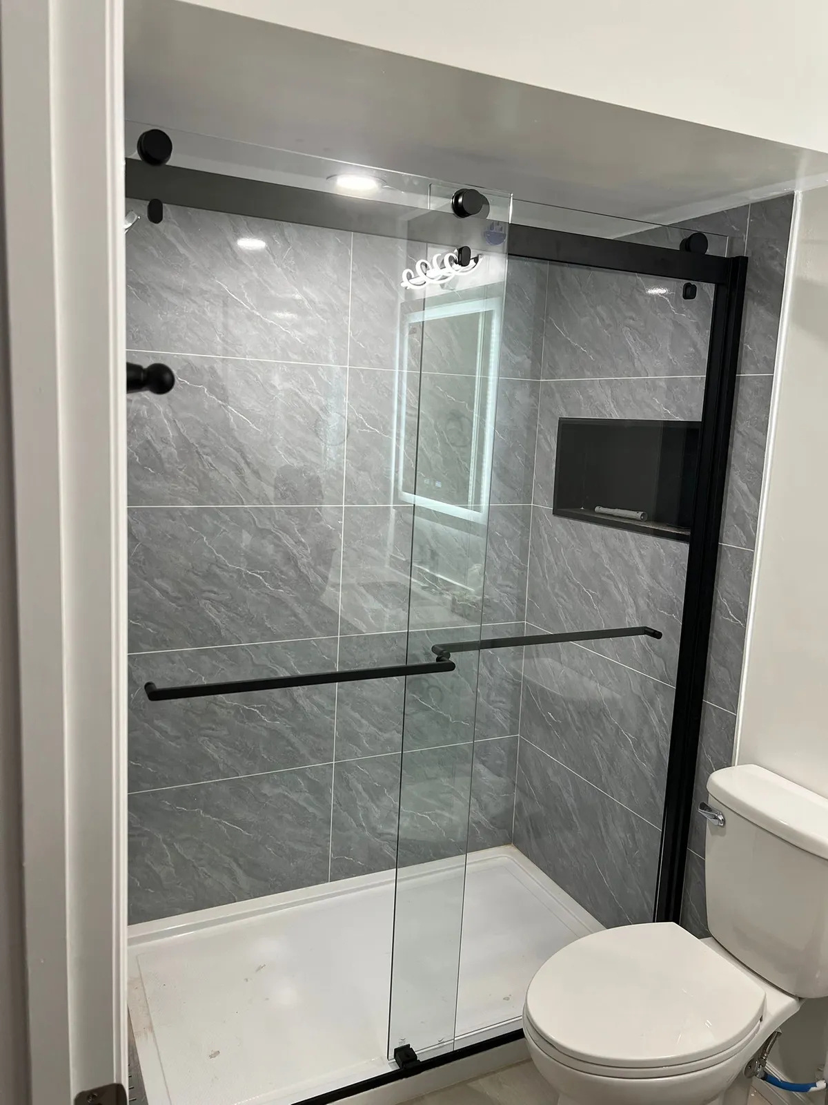 Large-format stone-look tile shower with recessed niche