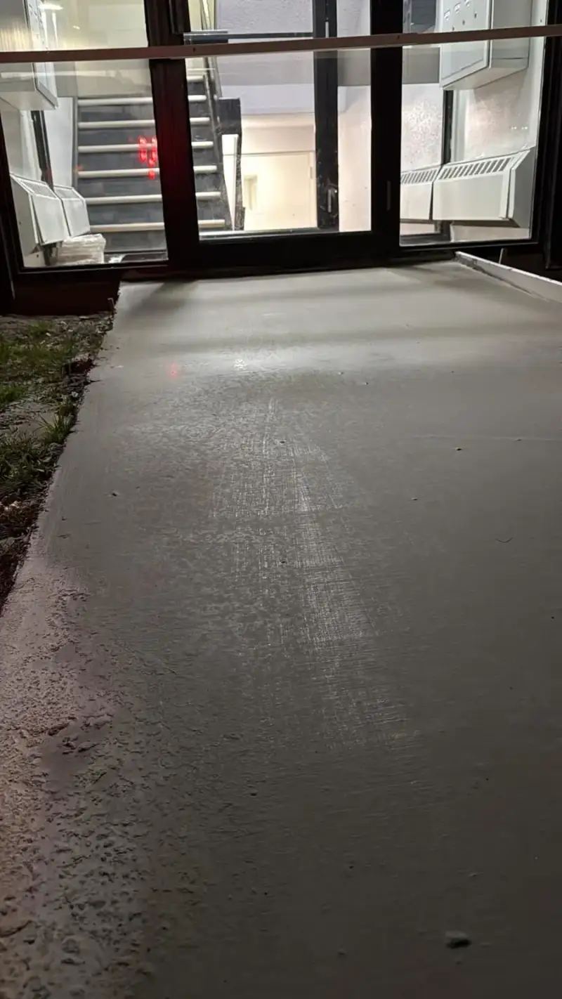 New concrete entrance walk with a broom finish at a Saskatoon apartment building