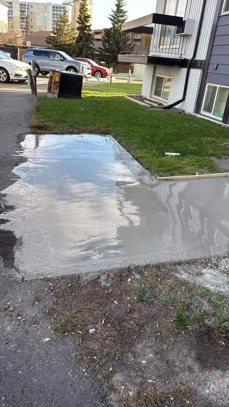 Fresh concrete walk poured from the parking lot along the lawn at an Avenue Living apartment building in Saskatoon