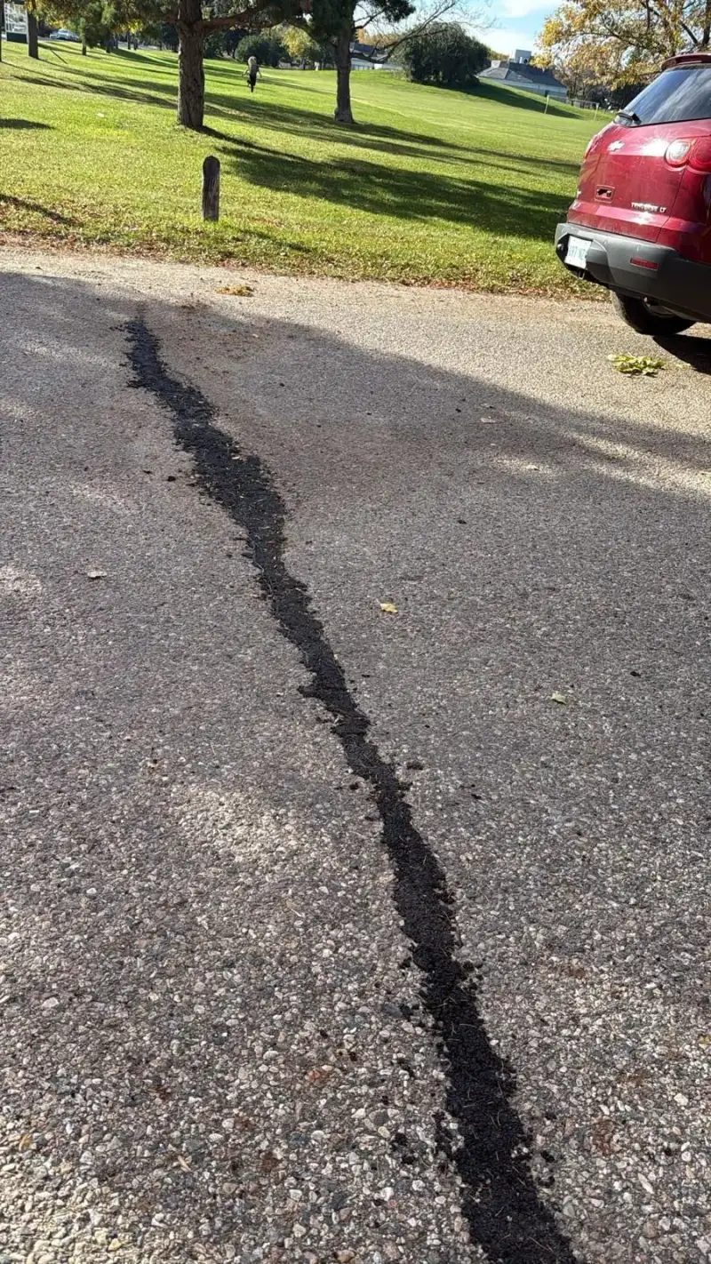 Long parking lot crack routed and filled with hot-pour sealant